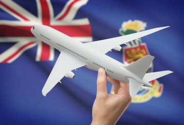 Uçağın içinde el ile arka plan - Cayman Adaları bayrağı