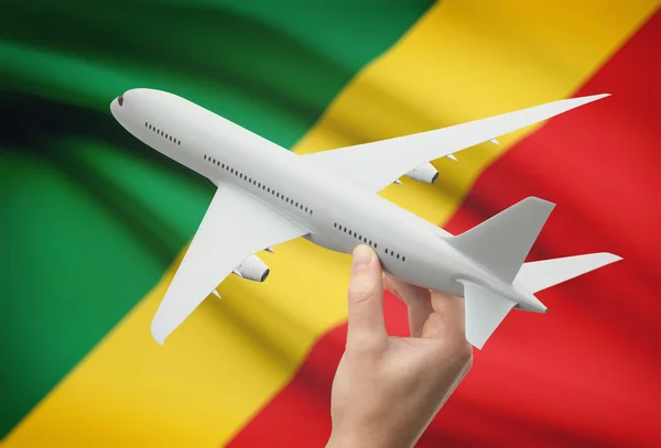 Самолет в руку с флагом на фоне - Конго-Браззавиль — стоковое фото
