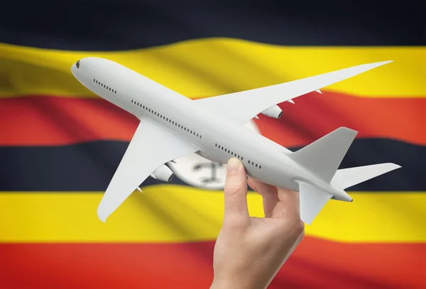 Самолет в руку с флагом на фоне - Уганда — стоковое фото
