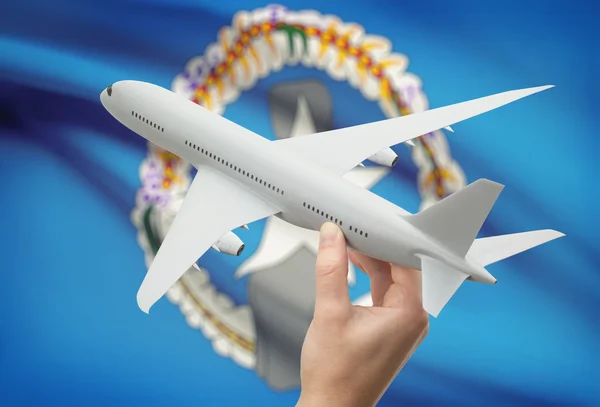 Airplane in hand with flag on background - Northern Mariana Islands — Stock Photo, Image