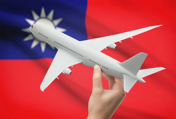 Airplane in hand with flag on background - Republic of China - Taiwan — Stock Photo, Image