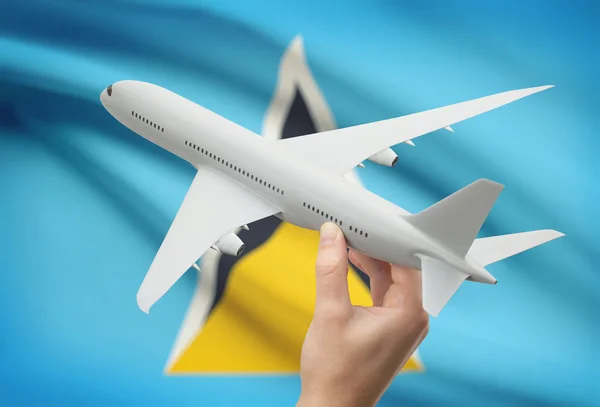 Avión en la mano con la bandera en el fondo - Santa Lucía —  Fotos de Stock