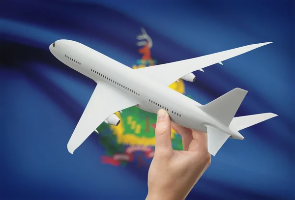 Airplane in hand with US state flag on background - Vermont — 图库照片