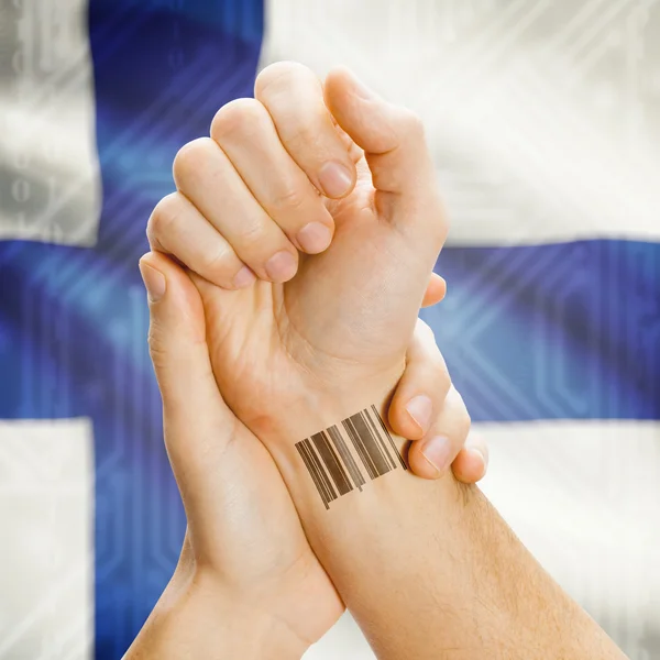 Barcode ID number on wrist and national flag on background series - Finland — Stock Photo, Image