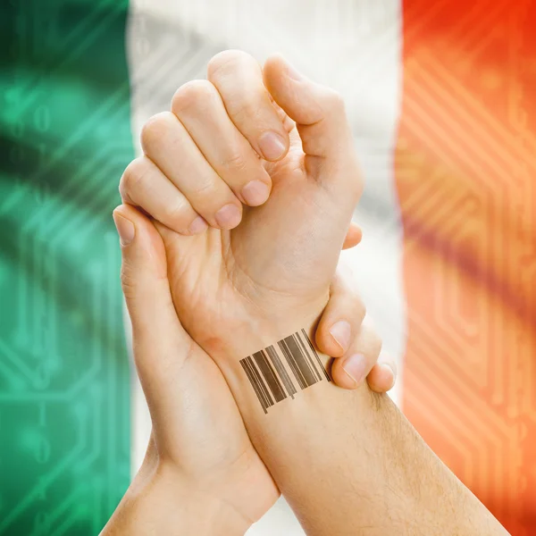 Barcode ID number on wrist and national flag on background series - Ireland — Stock Photo, Image