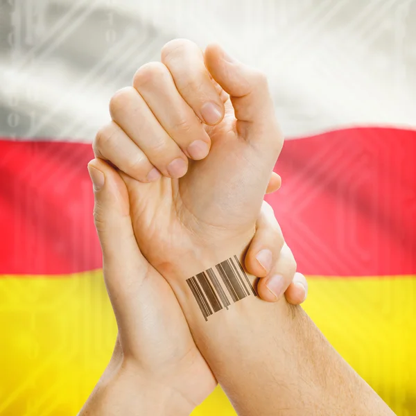 Barcode ID number on wrist and national flag on background series - South Ossetia — kuvapankkivalokuva