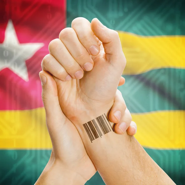 Barcode ID number on wrist and national flag on background series - Togo — Fotografia de Stock