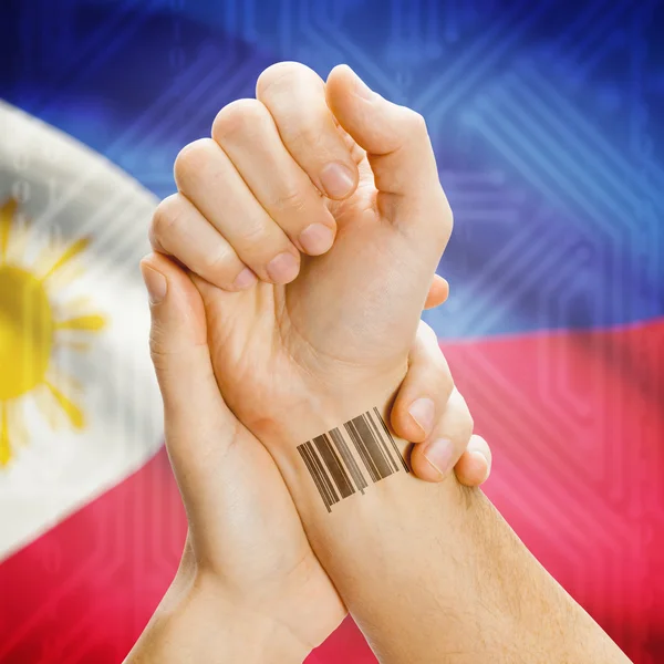 Barcode ID number on wrist and national flag on background series - Philippines — Zdjęcie stockowe