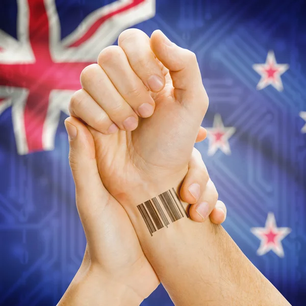 Barcode ID number on wrist and national flag on background series - New Zealand — Stock Fotó