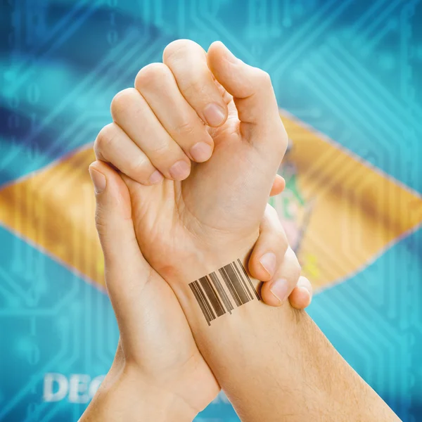 Barcode ID number on wrist and USA states flags on background series - Delaware — Stok fotoğraf