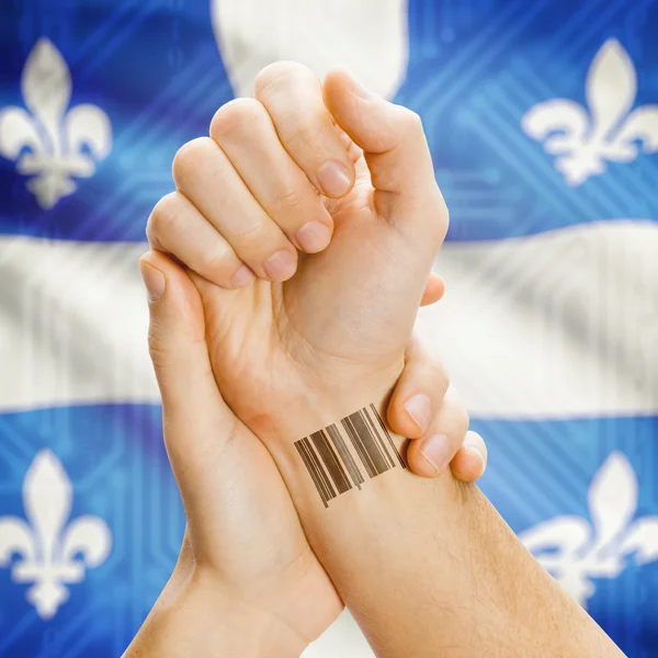 Barcode ID number on wrist with Canadian province flag on background series - Quebec — 图库照片