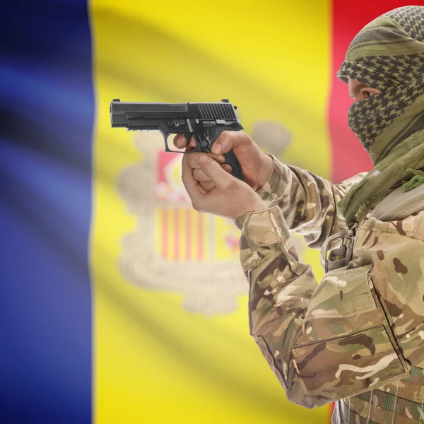 Male with gun in hands and national flag on background - Andorra — Stock Photo, Image