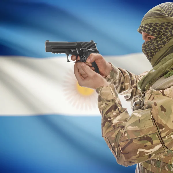 Male with gun in hands and national flag on background - Argentina — Stok Foto