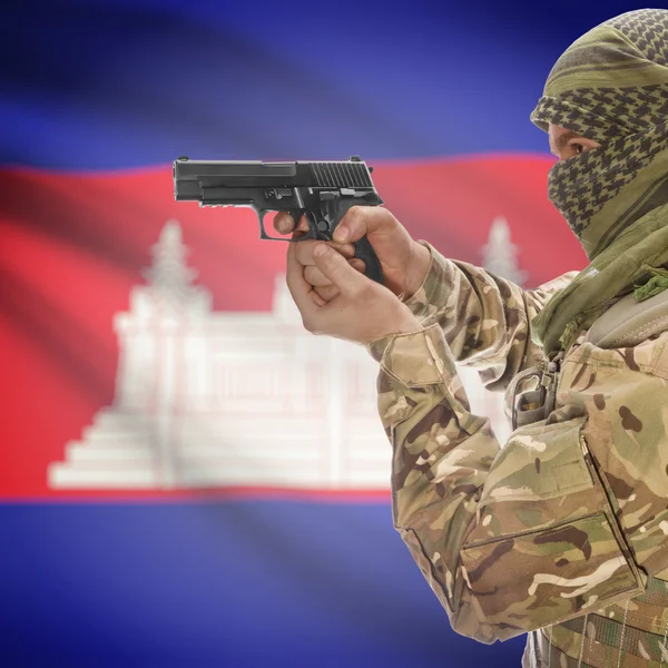 Male with gun in hands and national flag on background - Cambodia — Stok Foto