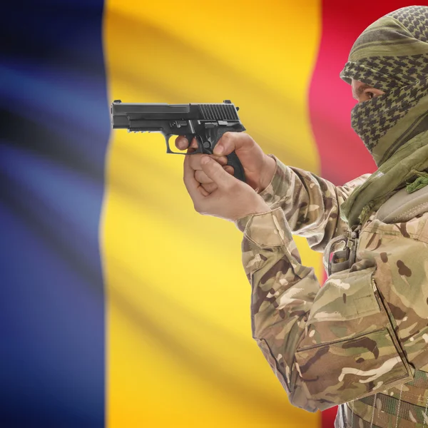 Male with gun in hands and national flag on background - Chad — Stock Photo, Image