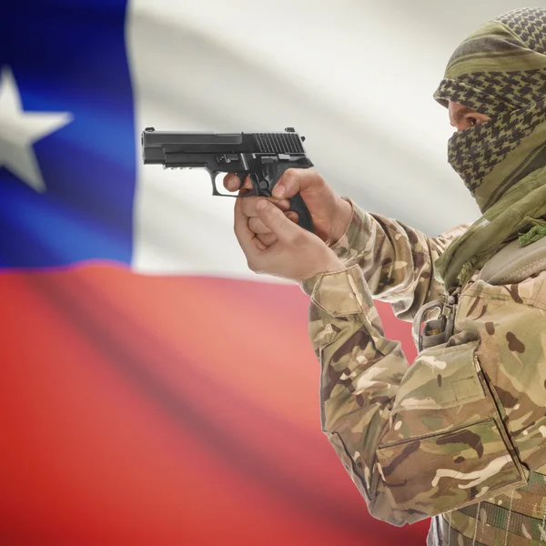 Male with gun in hands and national flag on background - Chile — Stok Foto