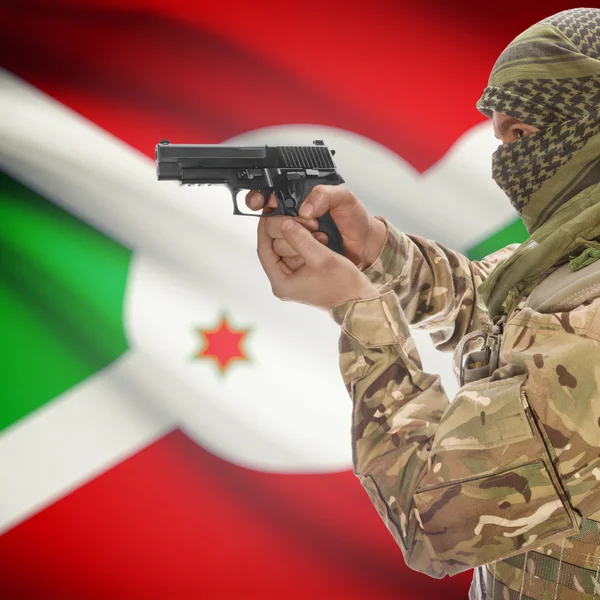 Male with gun in hands and national flag on background - Burundi — Stok Foto