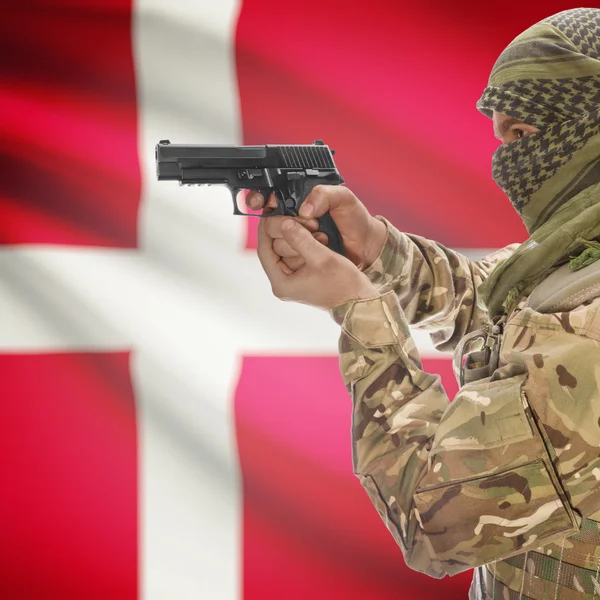 Male with gun in hands and national flag on background - Denmark — Stok Foto