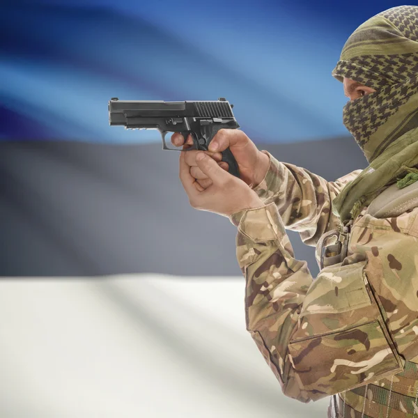 Male with gun in hands and national flag on background - Estonia — Stok Foto