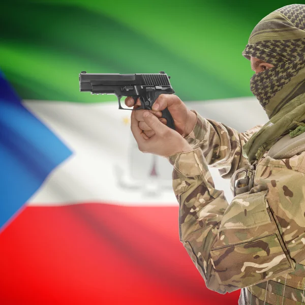 Male with gun in hands and national flag on background - Equatorial Guinea — Stok Foto