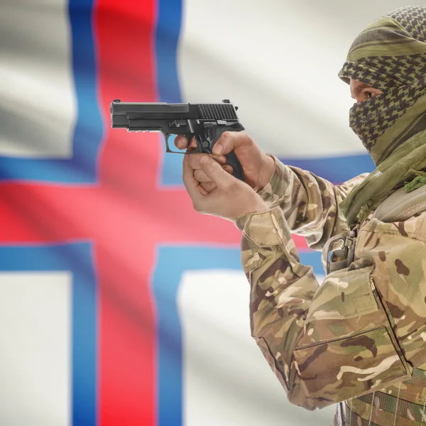 Male with gun in hands and national flag on background - Faroe Islands — Stock Photo, Image