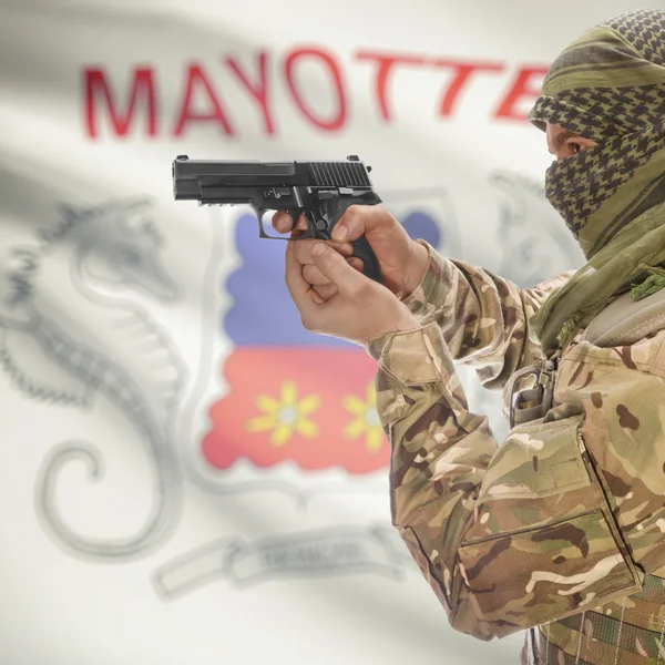 Male with gun in hands and national flag on background - Mayotte — Stok Foto