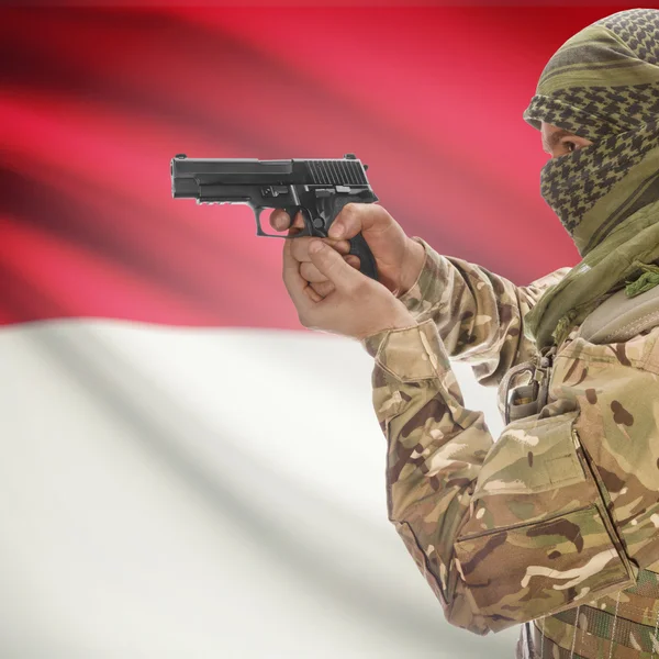 Male with gun in hands and national flag on background - Indonesia — Stok Foto