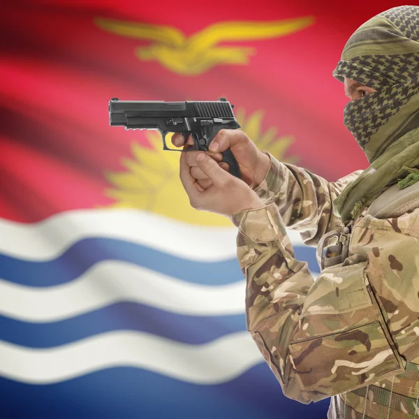 Male with gun in hands and national flag on background - Kiribati — Stok Foto