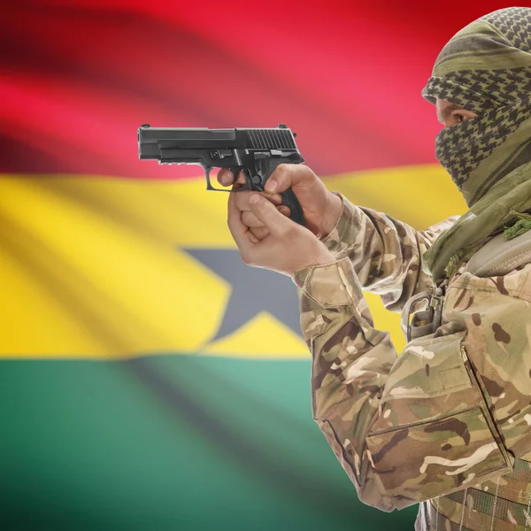 Male with gun in hands and national flag on background - Ghana — Stock Photo, Image
