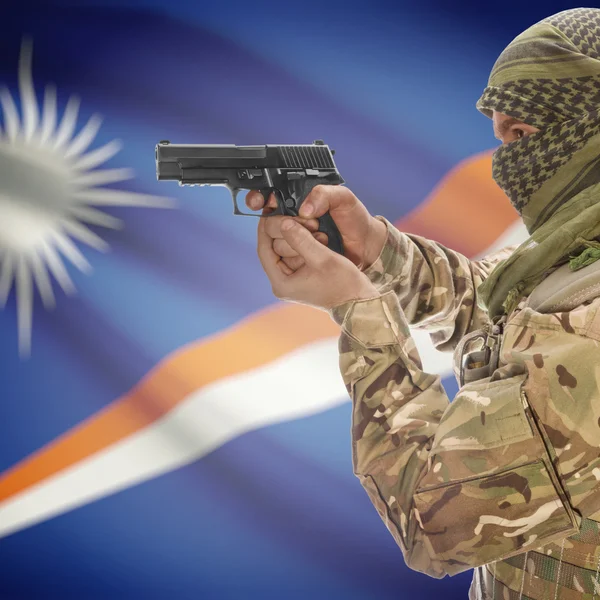 Male with gun in hands and national flag on background - Marshall Islands — Stok Foto