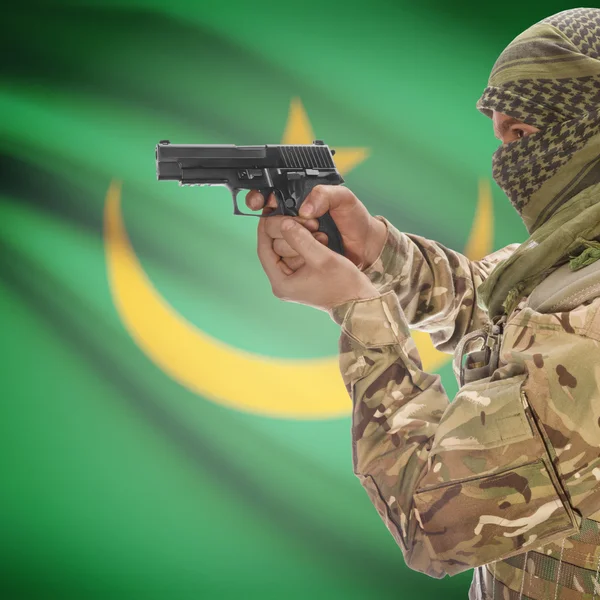 Male with gun in hands and national flag on background - Mauritania — Stok Foto