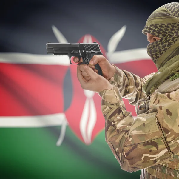 Male with gun in hands and national flag on background - Kenya — Stock Photo, Image