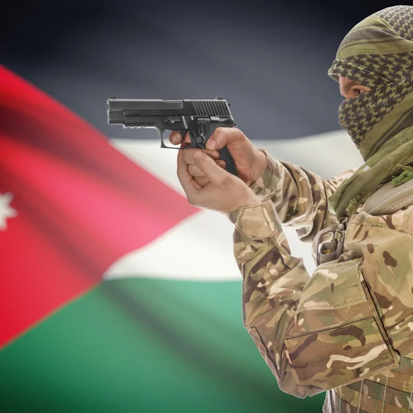 Male with gun in hands and national flag on background - Jordan — Stock Photo, Image