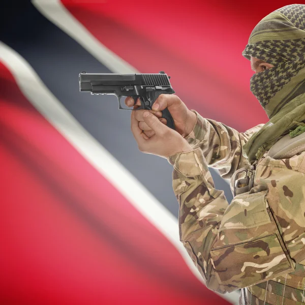 Male with gun in hands and national flag on background - Trinidad and Tobago — Stok Foto