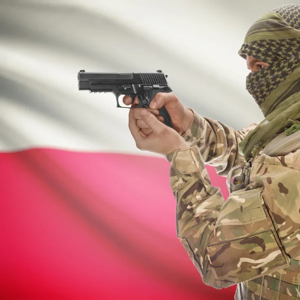 Male with gun in hands and national flag on background - Poland — Stock Photo, Image