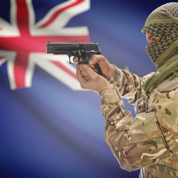 Male with gun in hands and national flag on background - New Zealand — Stok fotoğraf