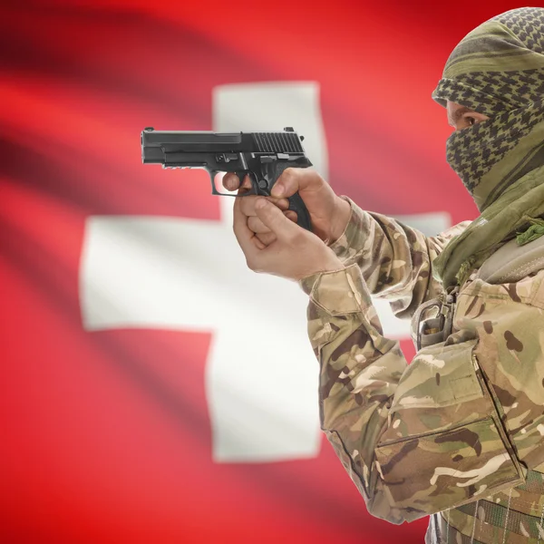 Male with gun in hands and national flag on background - Switzerland — Stok Foto