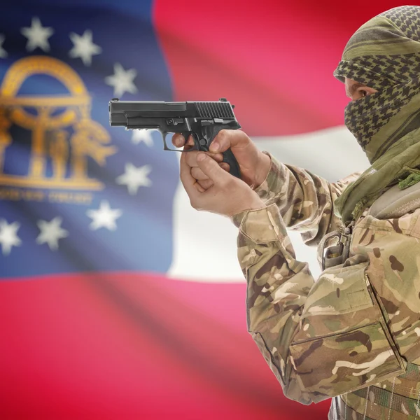 Male with gun in hands and USA state flag on background series - Georgia — стокове фото