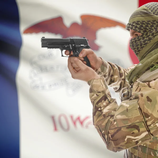 Male with gun in hands and USA state flag on background series - Iowa — стокове фото