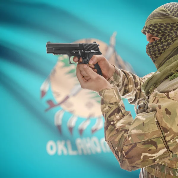 Male with gun in hands and USA state flag on background series - Oklahoma — стокове фото