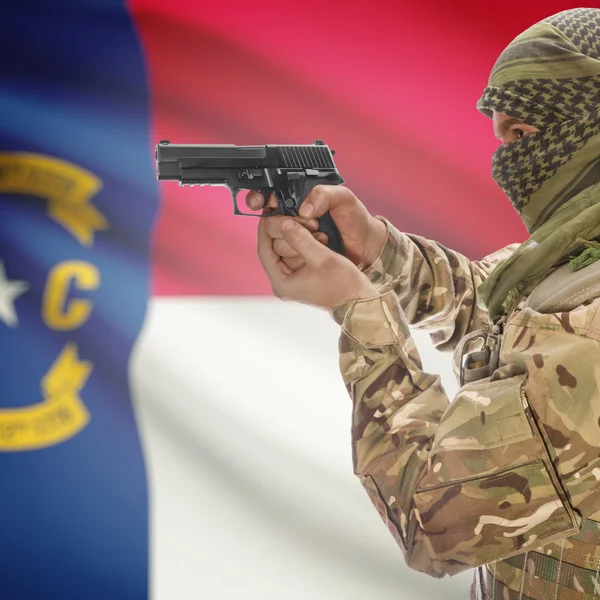 Male with gun in hands and USA state flag on background series - North Carolina — Stockfoto