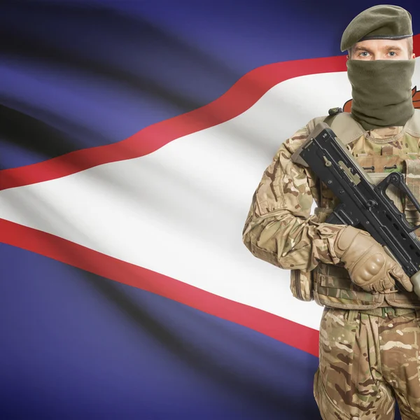 Soldier with machine gun and flag on background - American Samoa — Stok Foto