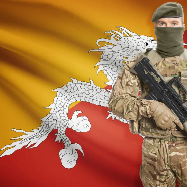 Soldier with machine gun and flag on background - Bhutan — Stok Foto