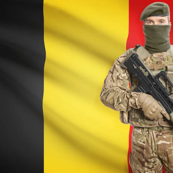 Soldier with machine gun and flag on background - Belgium — Stock Photo, Image