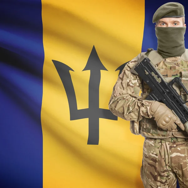 Soldier with machine gun and flag on background - Barbados — Stok Foto