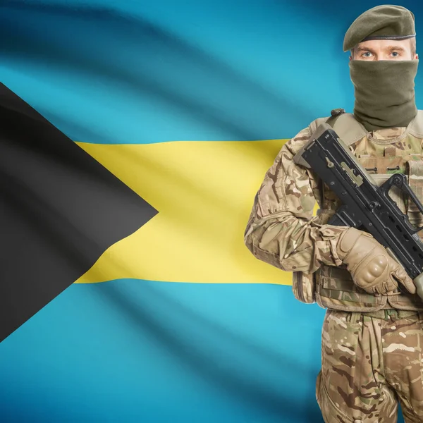 Soldier with machine gun and flag on background - Bahamas — Stok Foto