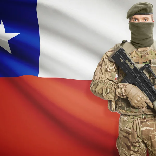 Soldier with machine gun and flag on background - Chile — Stok Foto