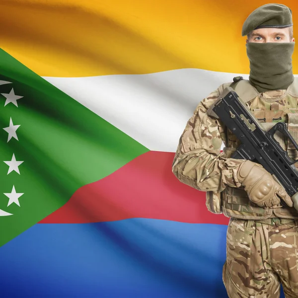Soldier with machine gun and flag on background - Comoros — Stok Foto