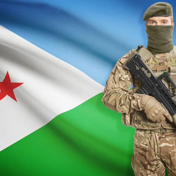 Soldier with machine gun and flag on background - Djibouti — kuvapankkivalokuva