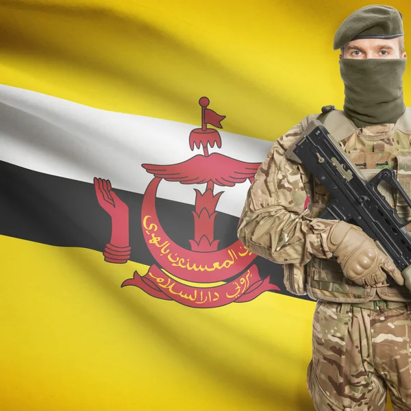 Soldier with machine gun and flag on background - Brunei — Stok Foto